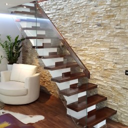 Wooden stairs with glass balustrade